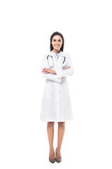 Full length view of joyful doctor in white coat standing with folded arms isolated on white