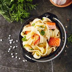 Homemade Italian Tagliatelle Pasta with fried Salmon Fillet