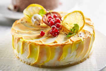 Macro Photo of Round Lemon Cheesecake Decorated on Blurred Background