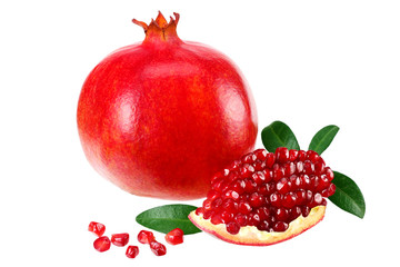 piece of pomegranate with seeds and green leaves isolated on a white background.