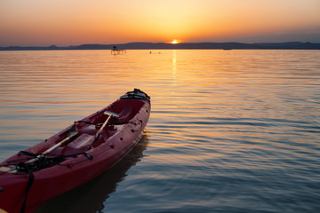 Sunset over lake Balaton with a kayak in the foreground