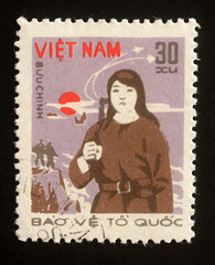 Stamp printed in Vietnam shows Militiary woman from the series Protect The Country, circa 1982.
