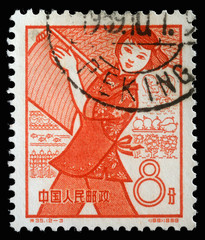 Stamp issued in the China shows Farming, the 1st Anniversary of People's Communes, circa 1959.