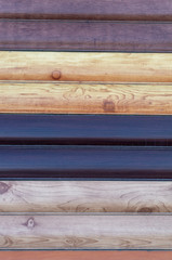 Metal tin cladding for the house, examples of different colors under the tree