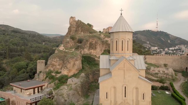 Aerial video. Old Tbilisi center from above. Drone top view on historical part of city. The Narikala fortress caught by quadrocopter