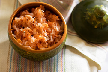 sauerkraut in a glossy cup on a linen napkin and a light background