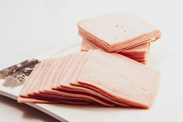 squared slice of lean pork ham , Sliced pork ham on a white background