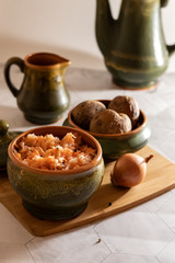 sauerkraut with boiled potatoes on a cutting board and a light background