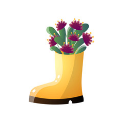 Purple flowers in creative vase like yellow boot isolated on white background