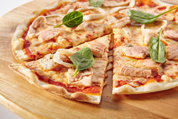 Hot Seafood Pizza on Wooden Plate Isolated