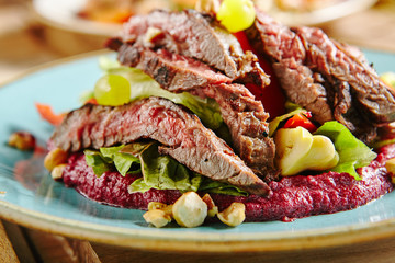Salad with Grilled Prime Beef or Thick Slices of Marbling Steak on Blue Plate