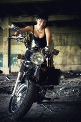 Fototapeta na wymiar Strong independent , self-sufficient girl with male fascination on chopper motorcycle, international womens day concept