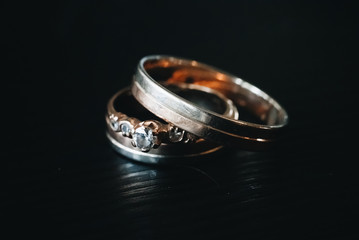 Wedding engagement rings on black background. Love concept.Selective focus.