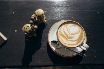 Coffee shop coffee in a white mug with a leaf design
