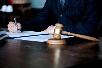 Legal counsel presents to the client a signed contract with gavel and legal law. justice and lawyer concept.