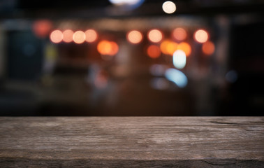 Empty dark wooden table in front of abstract blurred bokeh background of restaurant . can be used for display or montage your products.Mock up for space.