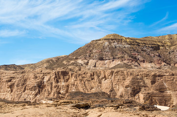 Obraz premium high rocky mountains in the desert against the blue sky and white clouds in Egypt Dahab South Sinai