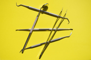Fototapeta na wymiar Tools for dental treatment on a yellow background