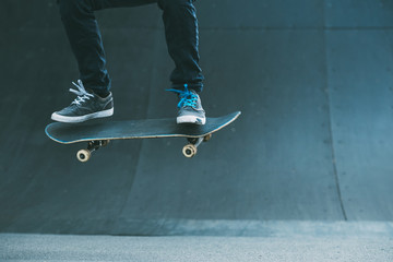 Skateboarding hobby. Man active life. Guy on skateboard performing ollie trick on ramp. Copy space.