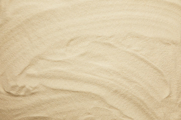 wavy, golden and textured sandy beach in summertime