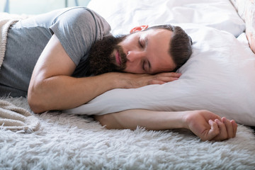 Obraz na płótnie Canvas Sound sleep. Healthy lifestyle. Comfy softness of warm bed. Man sleeping peacefully. Calm and coziness.