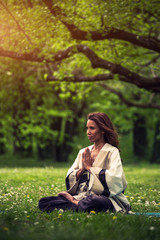 attractive woman practicing yoga in nature