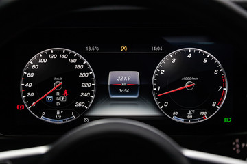 Сlose-up of the car  black interior:  dashboard, speedometer and tachometer and other buttons.