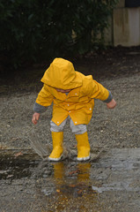 child in the rain with a yellow wax