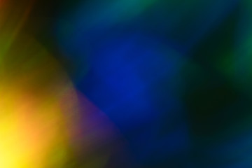 Blurry yellow light spot on dark background. Bokeh lens flare glow. Abstract design.