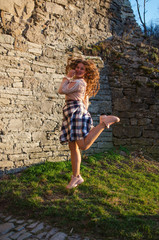 Fototapeta premium Young smiling girl with curly hair