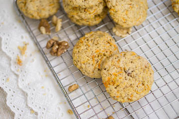 Oatmeal carrot cookies with nuts and milk close up selective focus