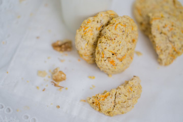 Oatmeal carrot cookies with nuts and milk close up selective focus