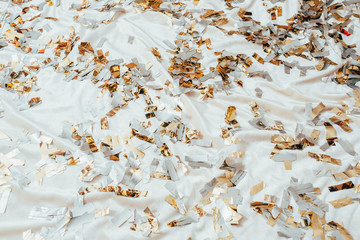 Glitter confetti on sheets background. Gold and silver. Party fun and joy. Leisure and relaxation. Urban luxury lifestyle.