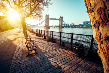A boulevard next to the river Thames with Tower Bridge in the distance