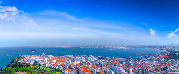Fototapeta premium Summertime sunshine day panoramic cityscape view of Almada, Tagus river, Portugal.