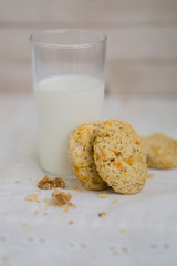 Oatmeal carrot cookies with nuts and milk close up selective focus