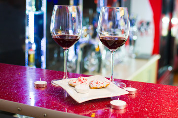 two glasses of wine and heart-shaped cookies. Valentine's Day