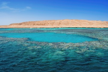 Beautiful turquoise tropical sea lagoon , coral reef and island