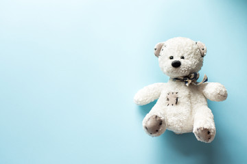 teddy bear child toy on pastel baby blue background with copy space
