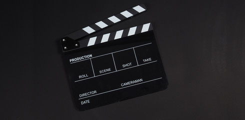 Fototapeta na wymiar Black Clapperboard or clap board or movie slate use in video production ,film, cinema industry on black background.