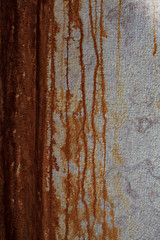 Wall with rust runoff, can be used as a background.