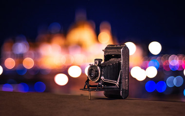 Old vintage photography retro camera in the night bokeh city Budapest