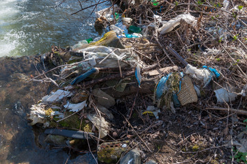 Plastic and foam garbage floating on the surface of the river