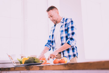 Angry man cooking alone in the kitchen