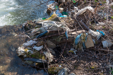 Plastic and foam garbage floating on the surface of the river