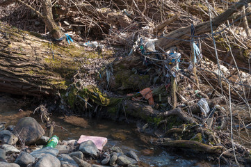 Plastic and foam garbage floating on the surface of the river