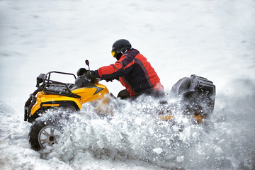Winter race on an ATV on snow in the forest. © Bondariev Volodymyr.