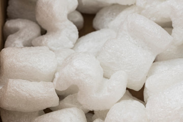 Fototapeta na wymiar S-shaped white packing peanuts as a background - Bilder