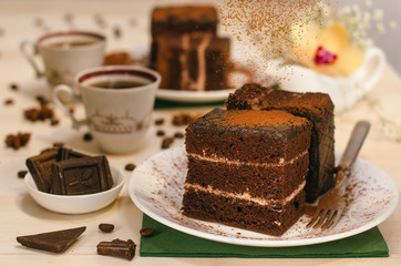 Still life on the table. Sweet cake and a hot drink . chocolate cake .