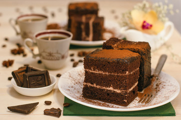 Still life on the table. Sweet cake and a hot drink . chocolate cake .